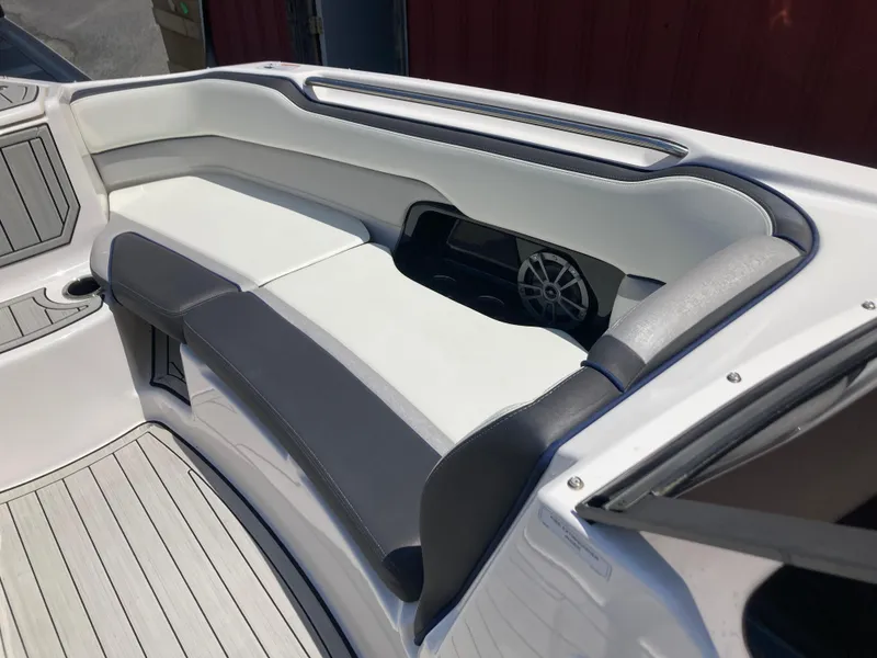 Slide: The Image of 2021 Yamaha Boats 252S interior seating with sleek design and integrated speaker system. - 18