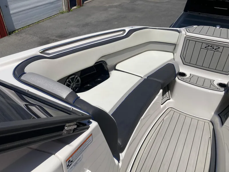 Slide: The Image of 2021 Yamaha Boats 252S interior with cushioned seating and cup holders. - 19