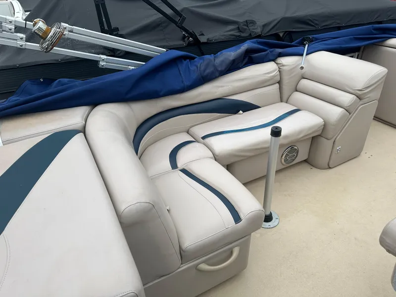 Slide: The Image of Luxurious seating on a 2014 Sweetwater Premium Edition 200 boat, featuring beige and blue upholstery. - 3