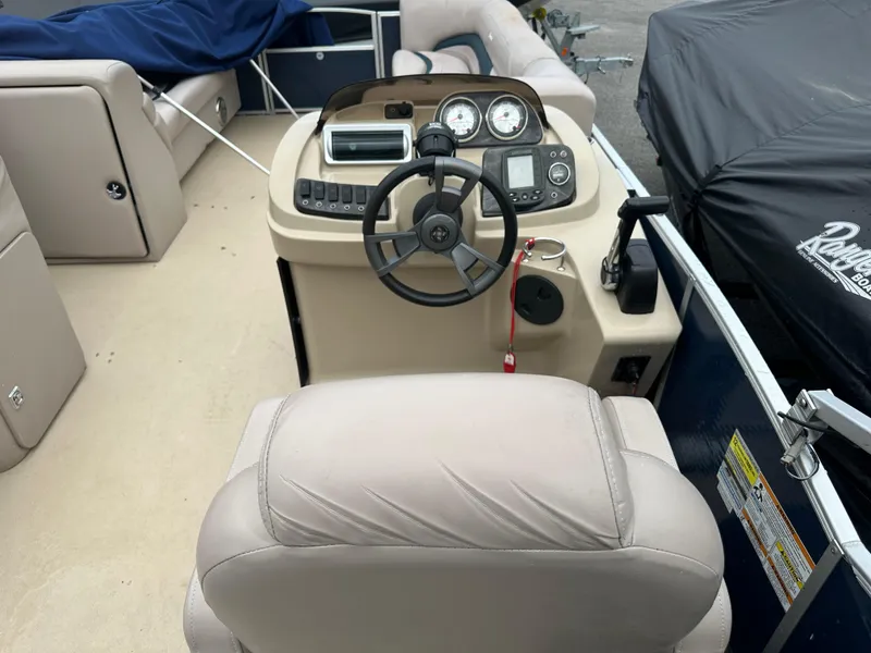 Slide: The Image of Interior of a 2014 Sweetwater Premium Edition 200 boat, featuring steering console and seating. - 8