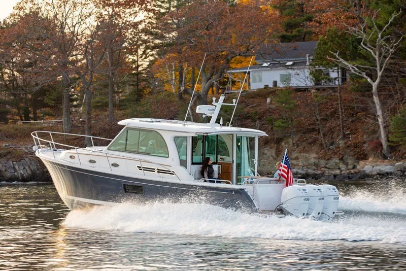 The Image of 2026 Back Cove 39O cruising on a scenic lake with autumn foliage. - 0