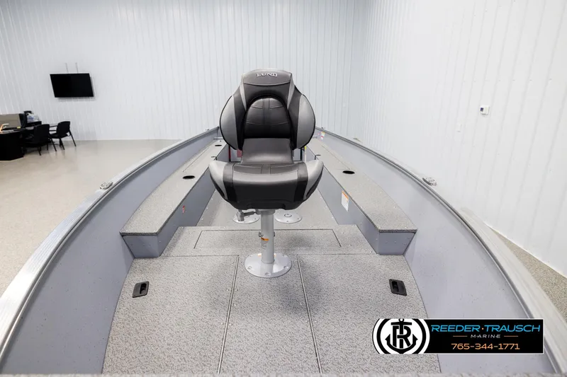 Slide: The Image of 2026 Lund 1600 Fury Tiller boat interior with swivel seat in showroom. - 11