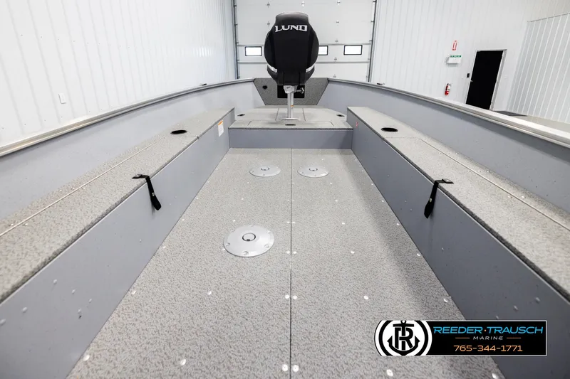 Slide: The Image of 2026 Lund 1600 Fury Tiller boat interior, spacious layout, gray finish, Reeder-Trausch Marine branding. - 14