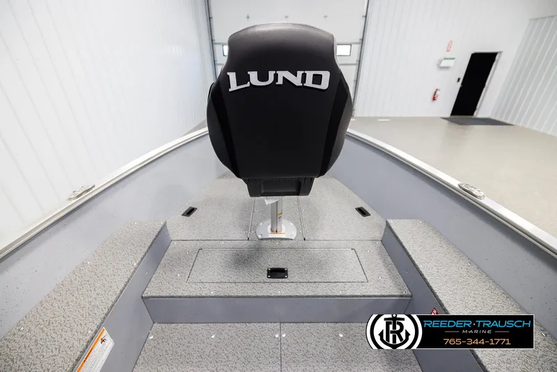Slide: The Image of 2026 Lund 1600 Fury Tiller boat interior with branded seat in showroom. - 16