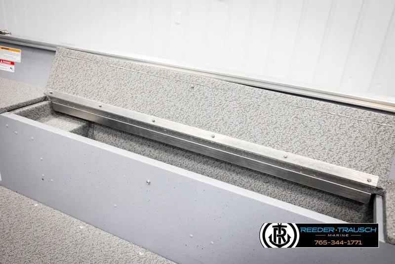 Slide: The Image of 2026 Lund 1600 Fury Tiller boat interior with storage compartment, Reeder-Trausch Marine logo. - 18