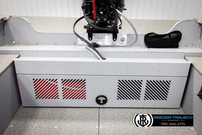 Slide: The Image of 2026 Lund 1600 Fury Tiller boat interior with storage compartment and motor, Reeder-Trausch Marine logo. - 23