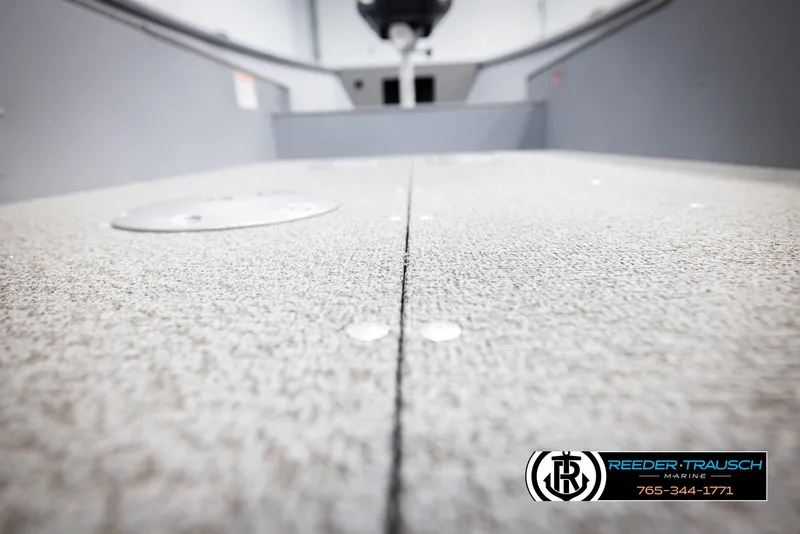 Slide: The Image of 2026 Lund 1600 Fury Tiller boat interior with textured flooring, Reeder-Trausch Marine logo visible. - 25