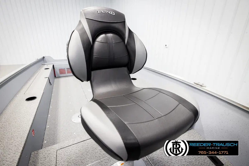 Slide: The Image of 2026 Lund 1600 Fury Tiller boat seat, black and gray, in a showroom setting. - 26