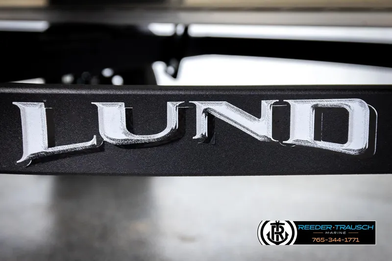 Slide: The Image of Close-up of 2026 Lund 1600 Fury Tiller logo on a boat trailer. - 38