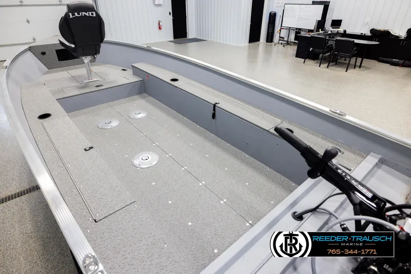 Slide: The Image of 2026 Lund 1600 Fury Tiller boat interior in showroom, featuring spacious layout and modern design. - 9