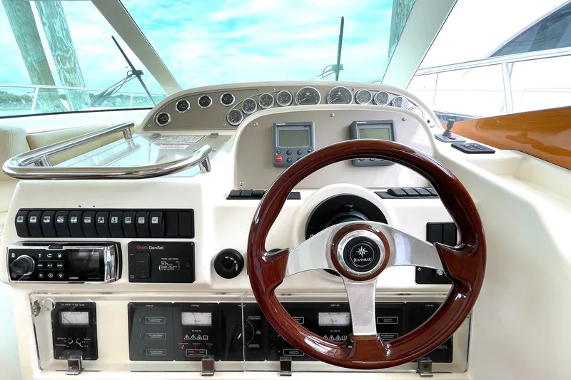 Slide: The Image of Control panel of a 2007 Prestige 46 Flybridge yacht with wooden steering wheel. - 12