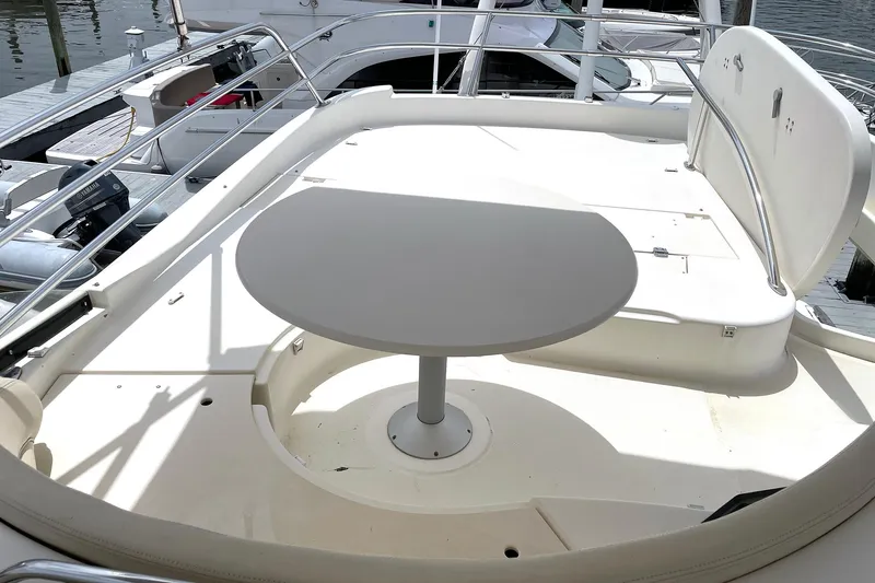 Slide: The Image of Flybridge seating area on 2007 Prestige 46 yacht with round table and railing. - 20