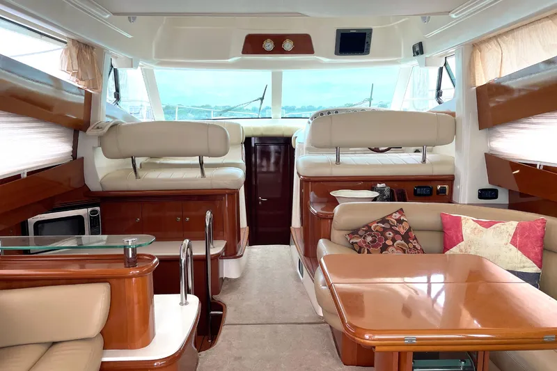 Slide: The Image of Luxurious interior of 2007 Prestige 46 Flybridge yacht with elegant seating and wooden finishes. - 6