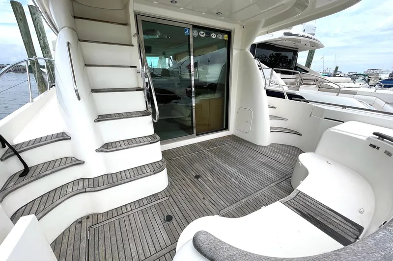 Slide: The Image of 2007 Prestige 46 Flybridge yacht deck with stairs and sliding glass door. - 7