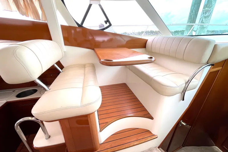 Slide: The Image of Luxurious seating area on 2007 Prestige 46 Flybridge yacht with wooden accents and white upholstery. - 9