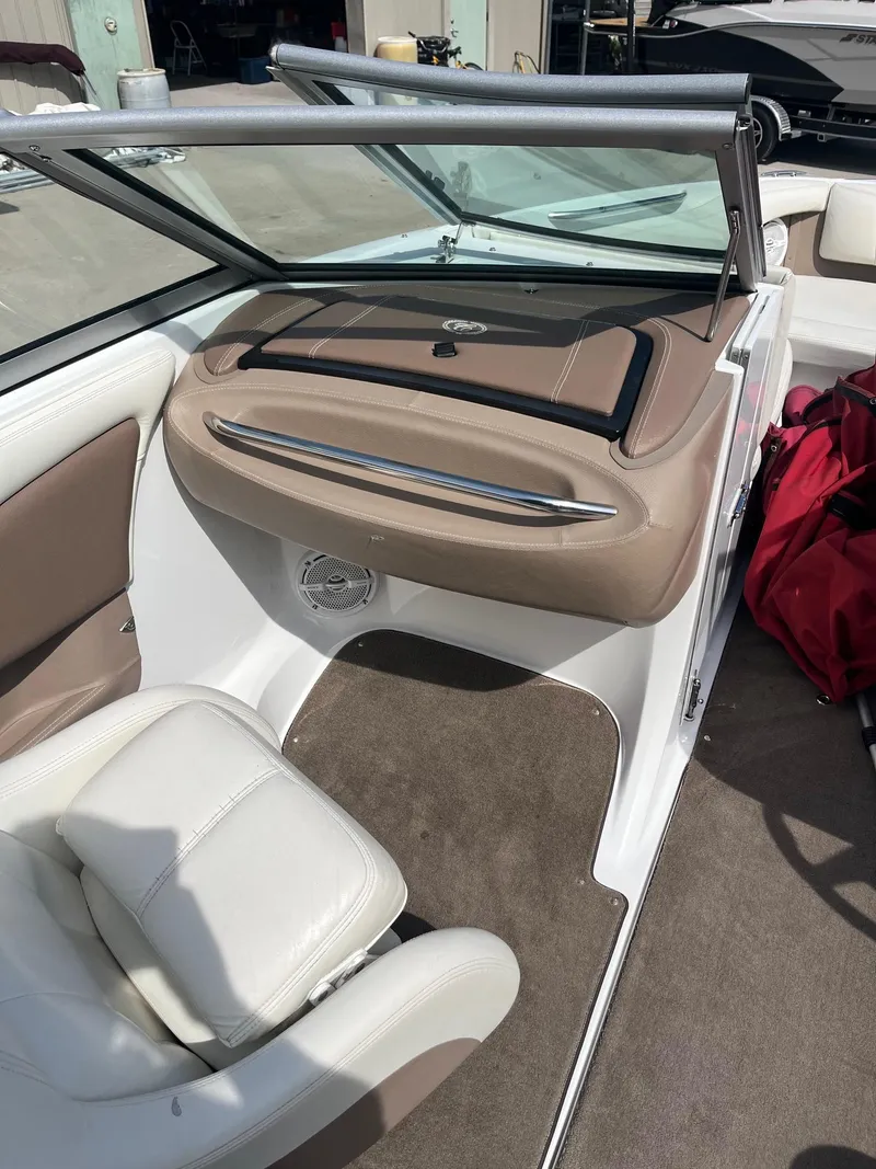 Slide: The Image of Interior of a 2009 Cobalt 210 boat with beige and white seating. - 4