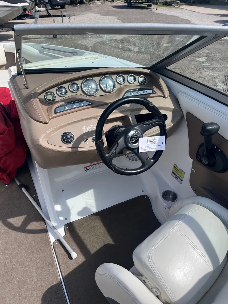 Slide: The Image of 2009 Cobalt 210 boat dashboard with steering wheel and instrument panel. - 5