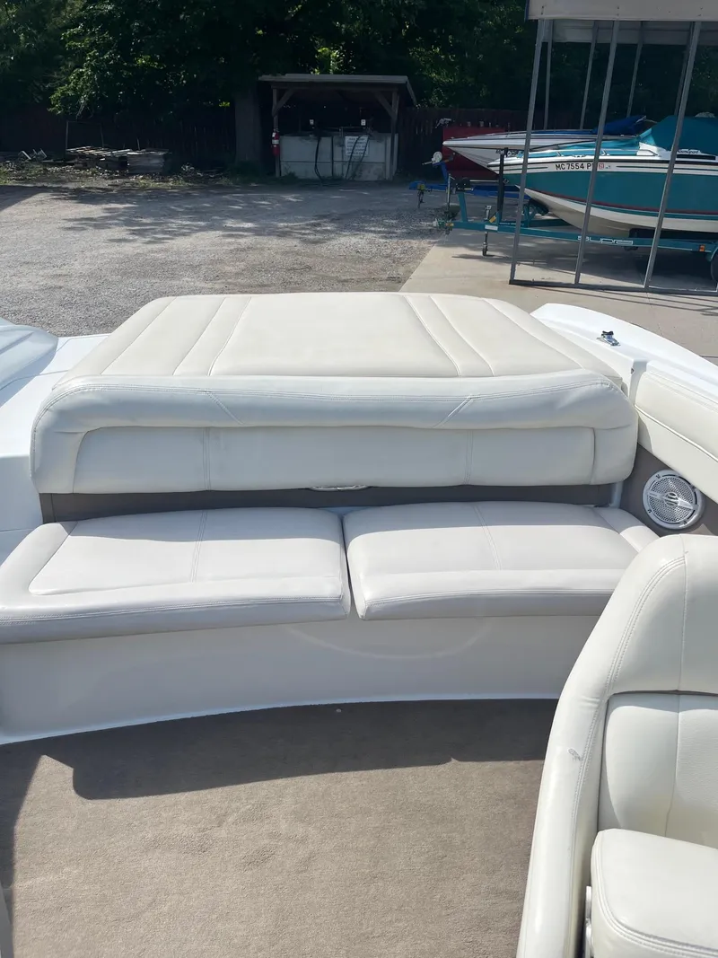 Slide: The Image of 2009 Cobalt 210 boat interior with white leather seating and sun pad. - 6