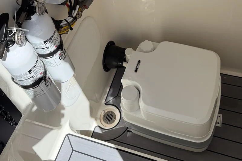 Slide: The Image of Portable toilet and fire extinguishers on 2024 Pathfinder 2700 Open boat. - 11