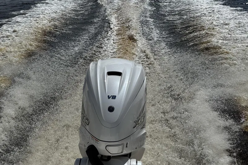 Slide: The Image of 2024 Pathfinder 2700 Open boat with powerful V8 engine creating dynamic water wake. - 13