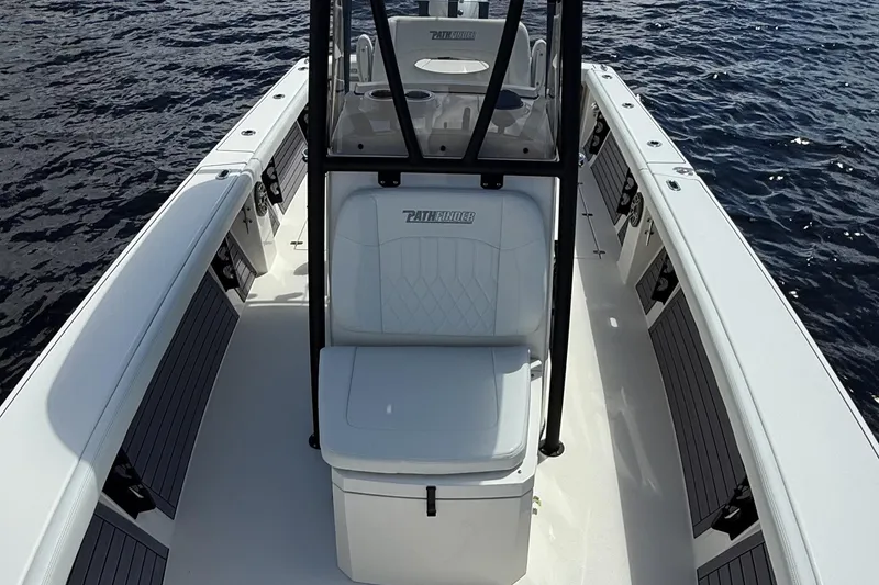 Slide: The Image of 2024 Pathfinder 2700 Open boat interior on water, showcasing seating and console design. - 14