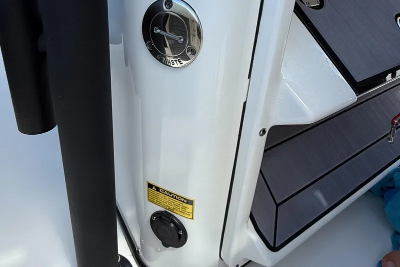 Slide: The Image of 2024 Pathfinder 2700 Open boat waste and caution labels on deck. - 16