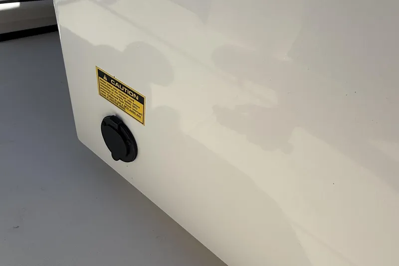 Slide: The Image of Caution label and cap on 2024 Pathfinder 2700 Open boat exterior. - 17
