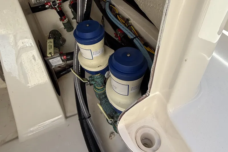 Slide: The Image of 2024 Pathfinder 2700 Open boat engine compartment with filters and wiring. - 19