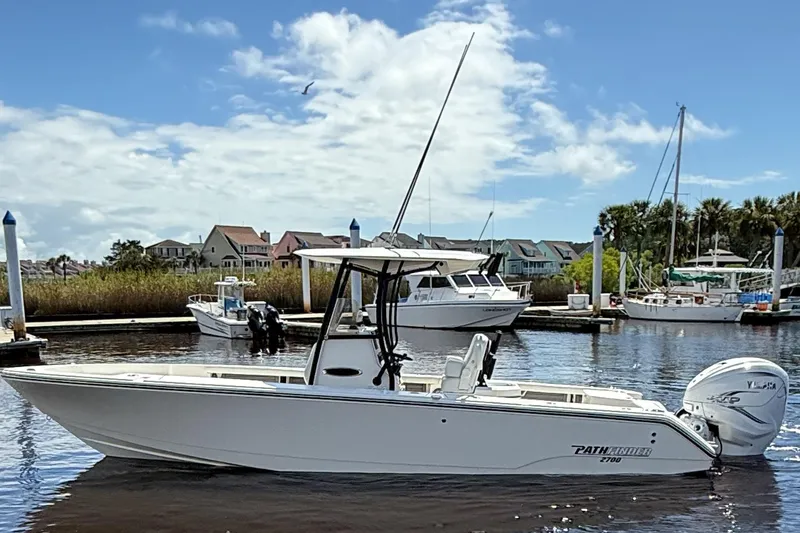 Slide: The Image of 2024 Pathfinder 2700 Open boat docked in a marina under a clear blue sky. - 2