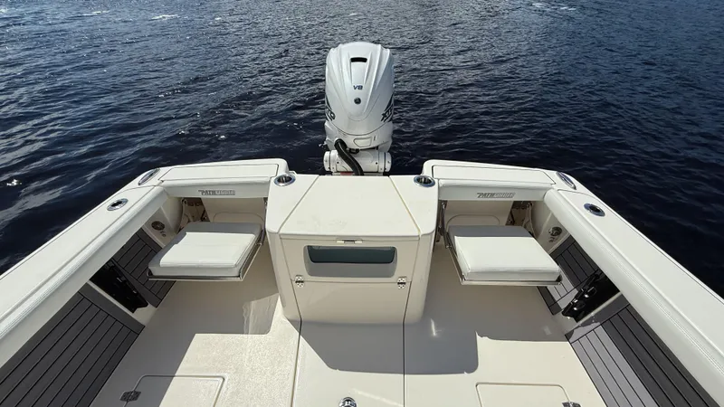 Slide: The Image of 2024 Pathfinder 2700 Open boat with seating and outboard motor on calm water. - 5