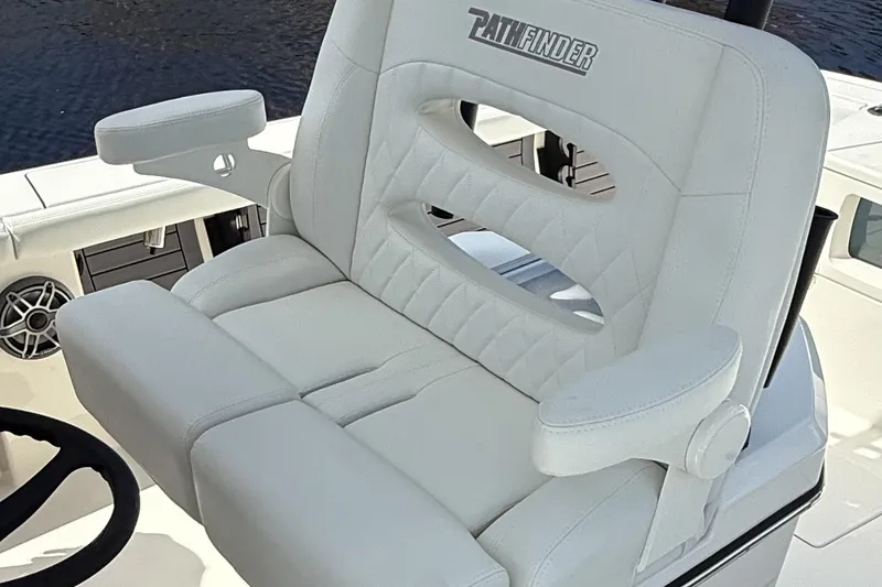 Slide: The Image of 2024 Pathfinder 2700 Open boat seat with armrests and logo, featuring white upholstery. - 7