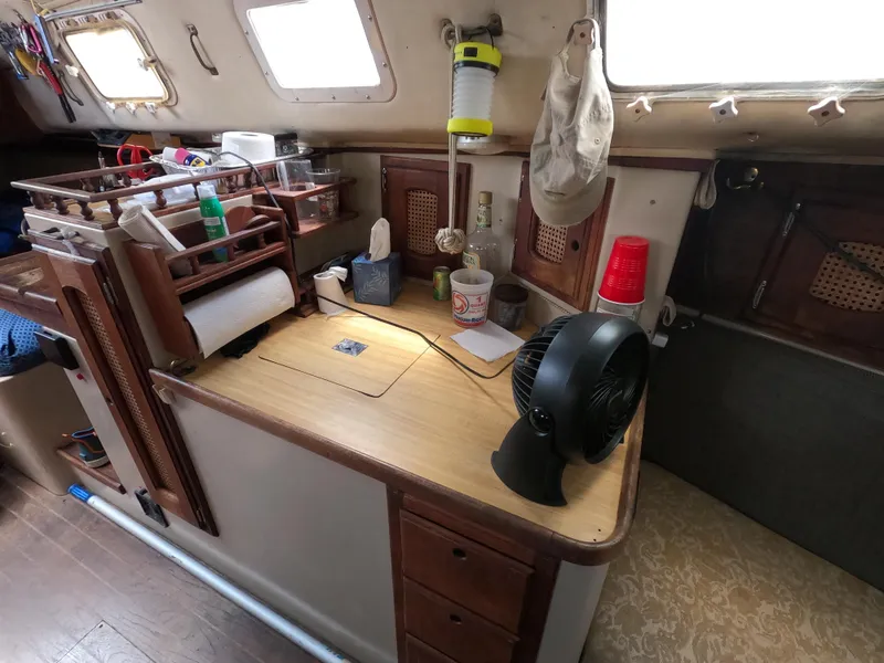 Slide: The Image of Interior of a 1984 Lancer 30 sailboat with a compact kitchen area. - 15