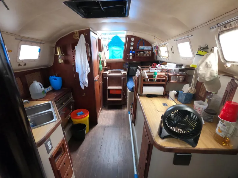 Slide: The Image of Interior of 1984 Lancer 30 sailboat with kitchen and storage areas. - 20