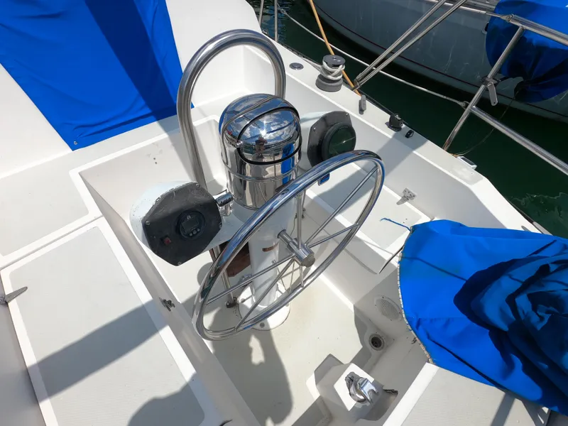 Slide: The Image of Steering wheel of a 1984 Lancer 30 sailboat with blue covers. - 5