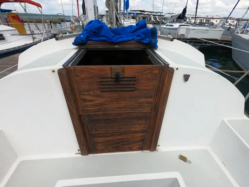 Slide: The Image of 1984 Lancer 30 sailboat cockpit with wooden hatch, docked at marina. - 8
