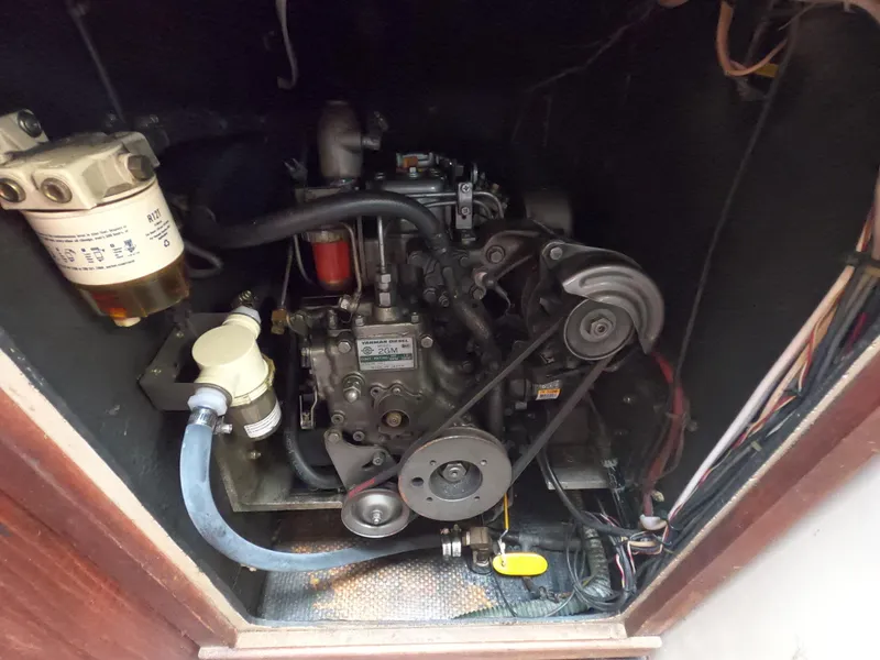 Slide: The Image of 1984 Lancer 30 engine compartment with Yanmar diesel engine and fuel filter system. - 24