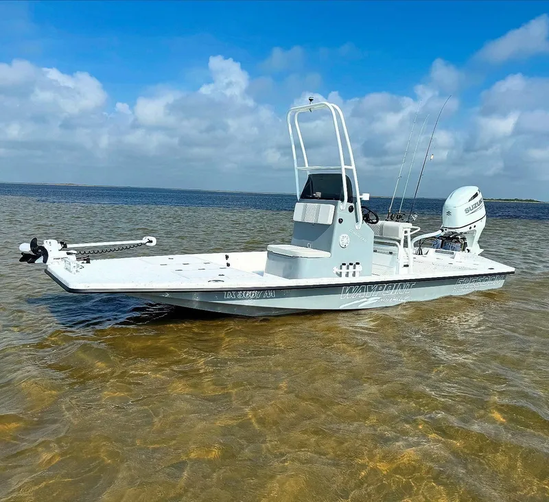 Slide: The Image of 2026 Freedom Boats USA 21' Commander in shallow water, clear sky background. - 3