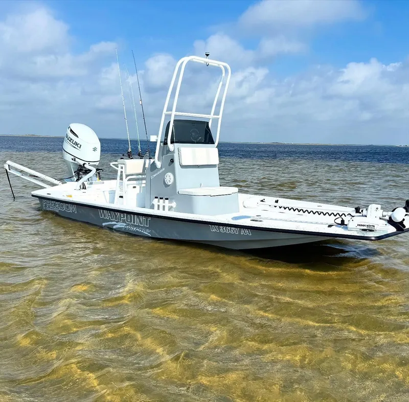 Slide: The Image of 2026 Freedom Boats USA 21' Commander in shallow water, featuring Suzuki outboard motor. - 4