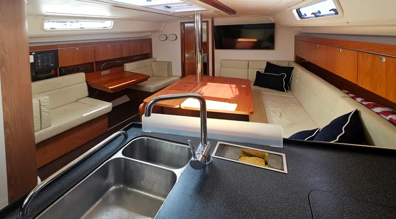 Slide: The Image of Interior of 2016 Hanse 415 yacht with modern kitchen and cozy seating area. - 13