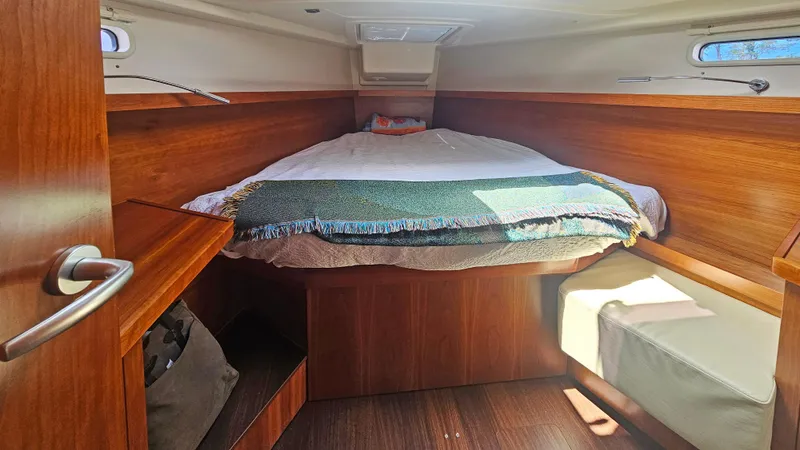 Slide: The Image of Cozy cabin interior of 2016 Hanse 415 yacht with wooden finish and comfortable bedding. - 21