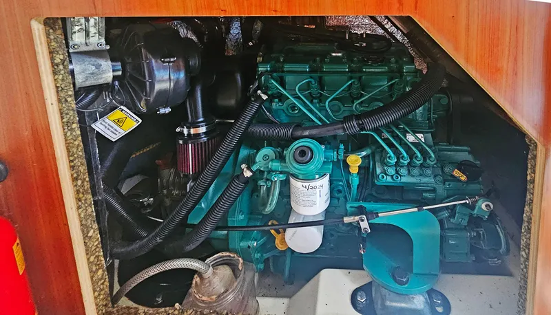 Slide: The Image of Engine compartment of a 2016 Hanse 415 sailboat, showcasing detailed mechanical components. - 26