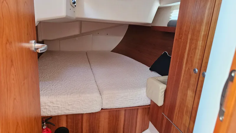 Slide: The Image of Cozy cabin interior of 2016 Hanse 415 yacht with wooden finish and comfortable bedding. - 27