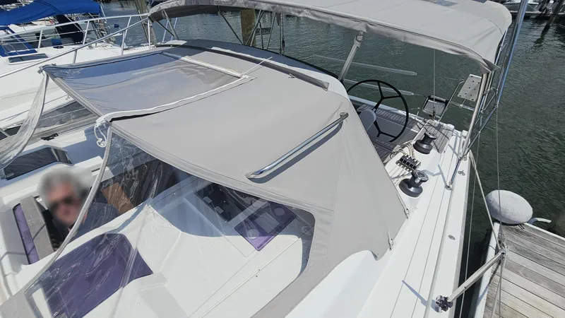 Slide: The Image of Sailing yacht Hanse 415, 2016 model, docked with covered cockpit and visible steering wheel. - 30
