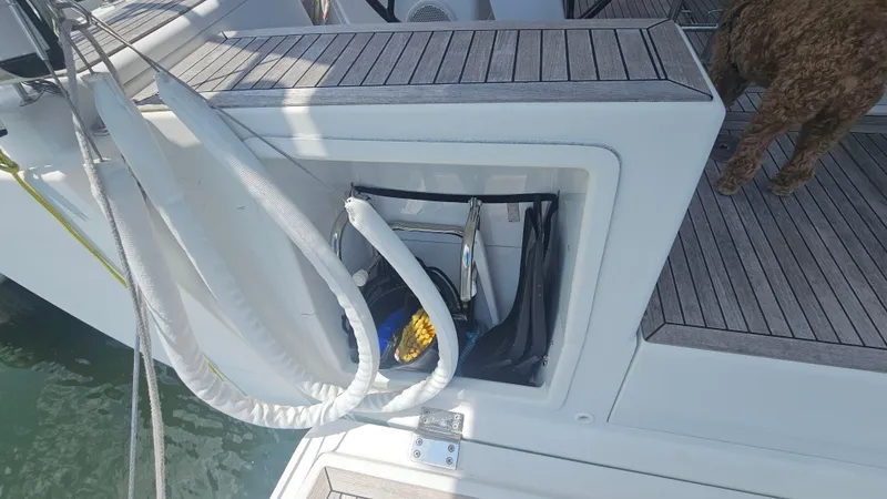 Slide: The Image of 2016 Hanse 415 yacht deck with storage compartment and coiled ropes. - 31