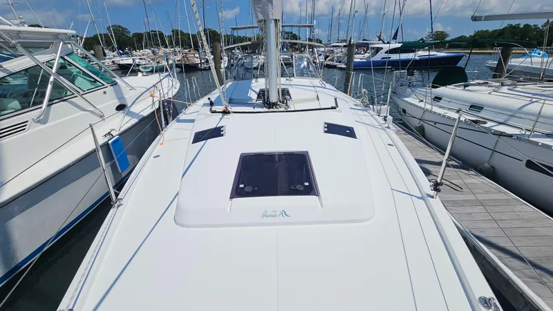 Slide: The Image of 2016 Hanse 415 sailboat docked at a marina, surrounded by other boats. - 34