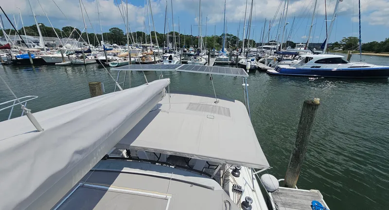Slide: The Image of 2016 Hanse 415 yacht docked at marina, surrounded by sailboats under a clear sky. - 36