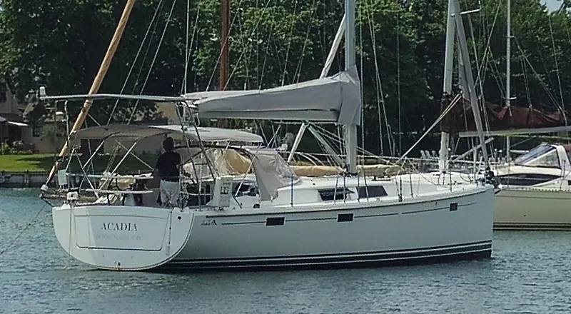 Slide: The Image of 2016 Hanse 415 sailboat on water, with trees in the background. - 5