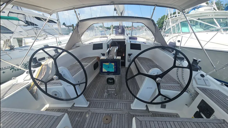 Slide: The Image of 2016 Hanse 415 yacht cockpit with dual steering wheels and navigation system. - 6