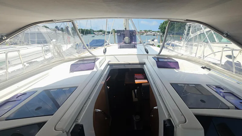 Slide: The Image of Interior view of 2016 Hanse 415 yacht, showcasing cockpit and marina surroundings. - 7