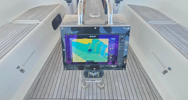 Slide: The Image of Cockpit of 2016 Hanse 415 yacht with navigation display and wooden flooring. - 9